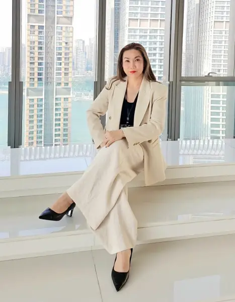 Vichaya Pengthong, Founder and CEO of Haven Group, in a light beige suit in a high-rise office